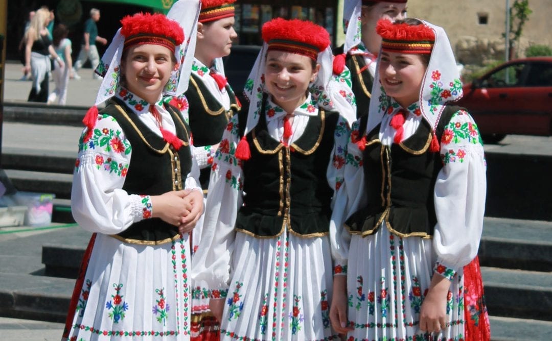 Three Girls Dressed in Ethinic Dance Clothing