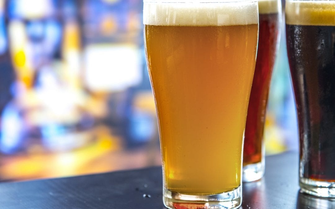 Different Colored Beers Sitting on Bar