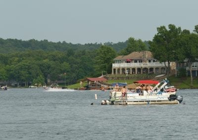 Boat on Lake with House in Distance